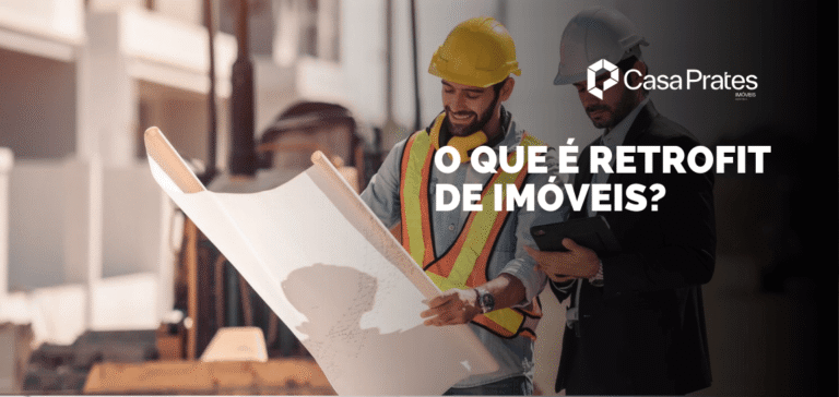 Engenheiros analisando planta de reforma em obra, com a frase “O que é retrofit de imóveis?”, representando modernização de construções antigas.